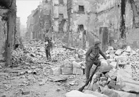 Capturing Caen: British soldier (center rear) carries small girl through devastation of Caen, July 10, 1944
